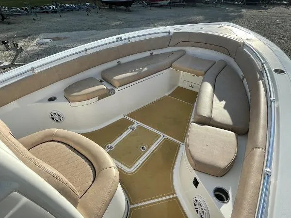 Slide: The Image of 2019 Sportsman 282 boat interior with beige seating and spacious deck layout. - 7