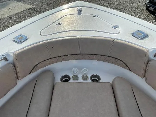 Slide: The Image of Bow seating area of 2019 Sportsman 282 boat with cushioned seats and storage compartments. - 9