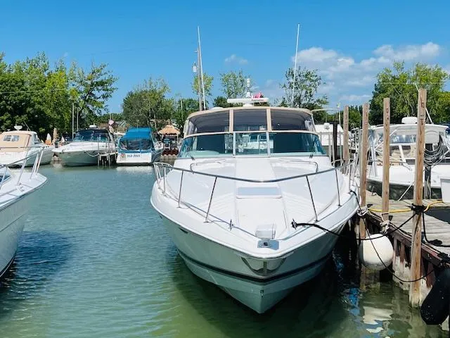 Slide: The Image of 2000 Formula 41 PC yacht docked in a marina, surrounded by other boats. - 1