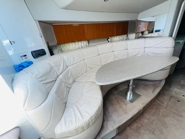 Slide: The Image of Luxurious interior of a 2000 Formula 41 PC yacht with plush seating and elegant table. - 13