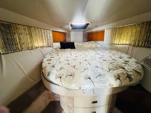 Slide: The Image of Cozy cabin interior of 2000 Formula 41 PC yacht with elegant bedding and soft lighting. - 17