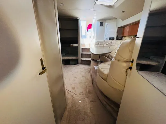 Slide: The Image of Interior of 2000 Formula 41 PC yacht with beige seating and carpeted flooring. - 22
