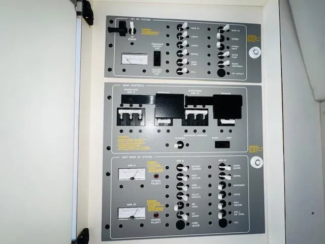 Slide: The Image of Electrical control panel of a 2000 Formula 41 PC boat, featuring switches and meters. - 24
