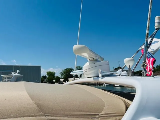 Slide: The Image of 2000 Formula 41 PC yacht with radar equipment and American flag, under clear blue sky. - 26