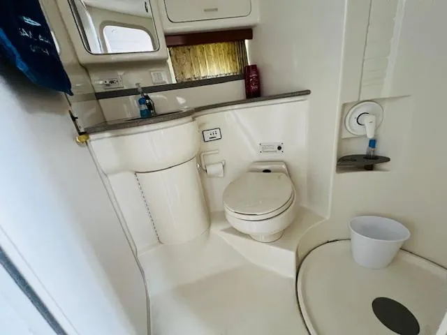 Slide: The Image of Bathroom interior of 2000 Formula 41 PC yacht, featuring toilet, sink, and shower area. - 27