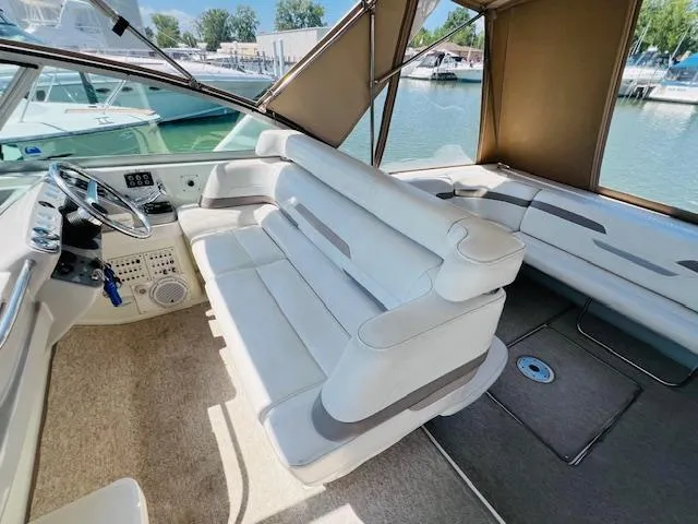 Slide: The Image of Interior of 2000 Formula 41 PC yacht with white seating and helm, docked at marina. - 5