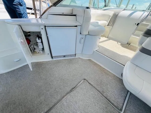 Slide: The Image of Interior of a 2000 Formula 41 PC yacht with white seating and open storage compartment. - 7