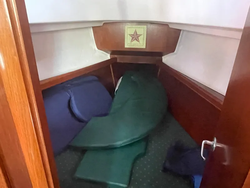 Slide: The Image of Cabin interior of 1999 Beneteau Oceanis 36 CC sailboat with cushions and wooden finish. - 11