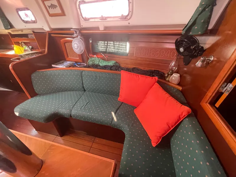 Slide: The Image of Interior of 1999 Beneteau Oceanis 36 CC sailboat with green seating and red cushions. - 13