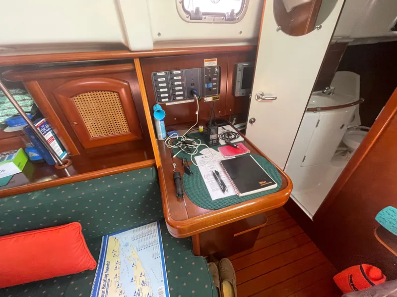 Slide: The Image of Interior of 1999 Beneteau Oceanis 36 CC sailboat with navigation station and cozy seating area. - 15