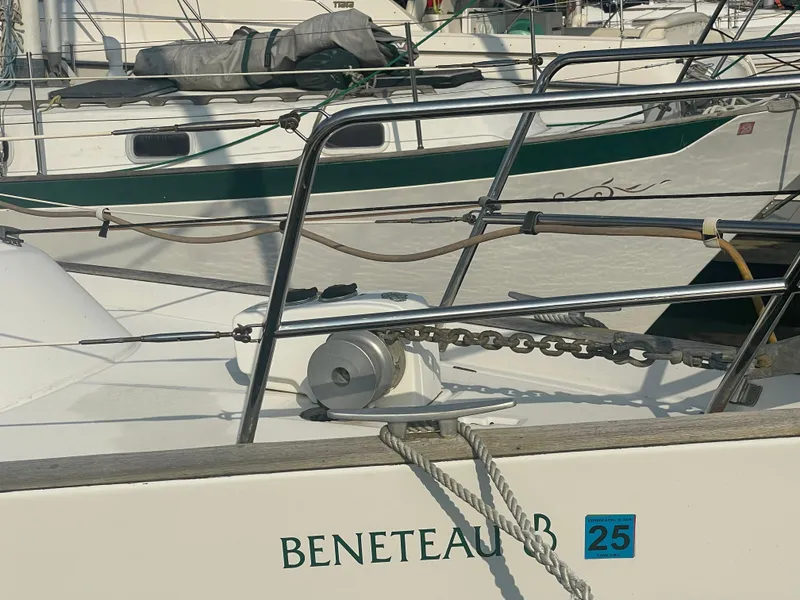 Slide: The Image of Beneteau Oceanis 36 CC sailboat, 1999 model, docked with visible anchor chain and railing. - 2