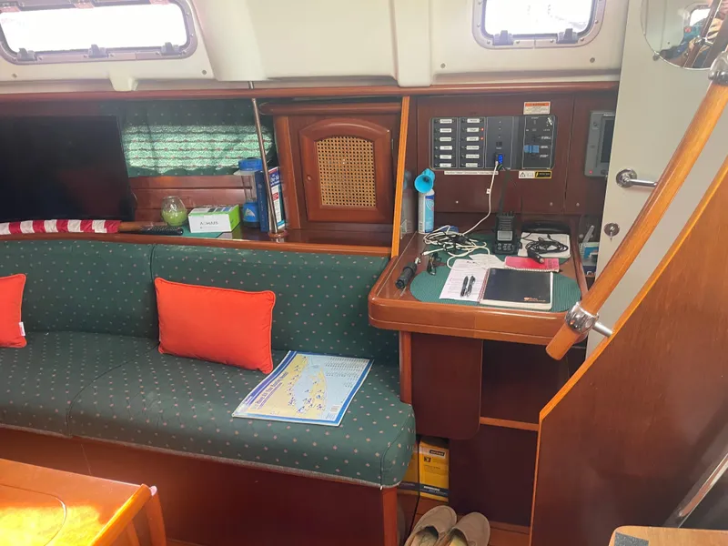 Slide: The Image of Interior of 1999 Beneteau Oceanis 36 CC sailboat with seating, navigation station, and nautical decor. - 21