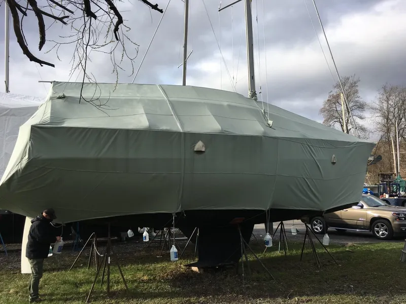 Slide: The Image of 1999 Beneteau Oceanis 36 CC sailboat covered and stored outdoors. - 22