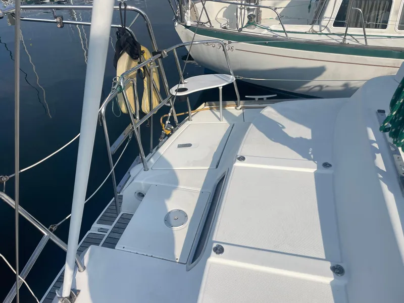 Slide: The Image of 1999 Beneteau Oceanis 36 CC yacht deck, featuring clean white surfaces and railing. - 3