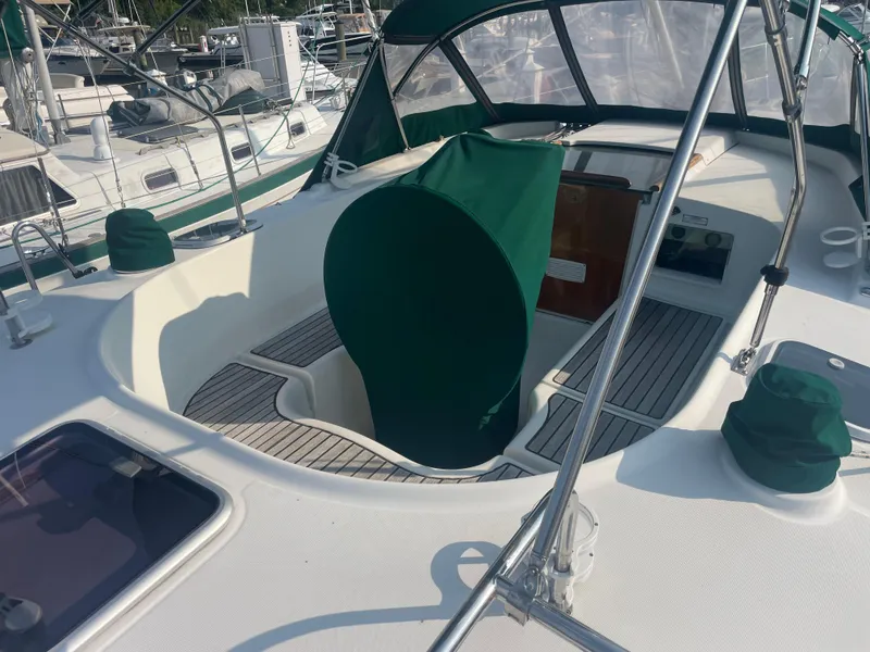 Slide: The Image of 1999 Beneteau Oceanis 36 CC sailboat cockpit with green covers and teak flooring. - 4