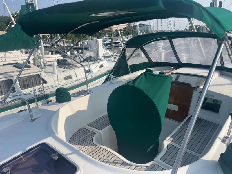 Slide: The Image of 1999 Beneteau Oceanis 36 CC sailboat cockpit with green canopy and seating. - 6
