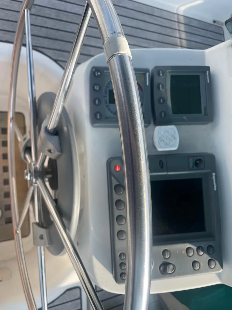 Slide: The Image of 1999 Beneteau Oceanis 36 CC yacht helm with navigation instruments and steering wheel. - 9