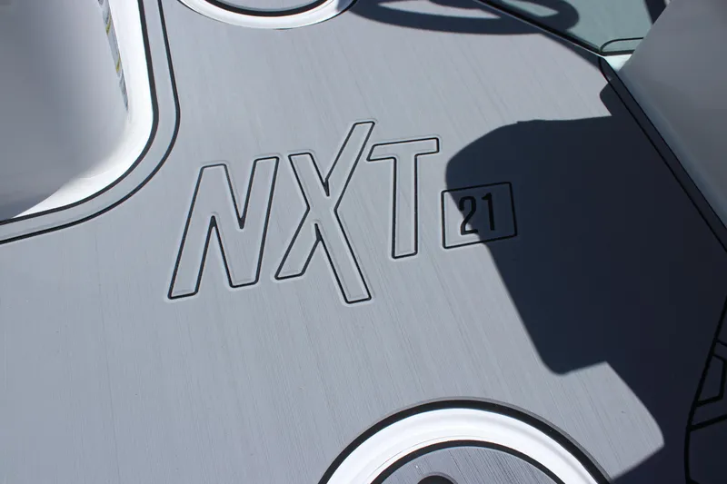 Slide: The Image of 2025 MasterCraft NXT21 boat deck with embossed logo and sleek design. - 15