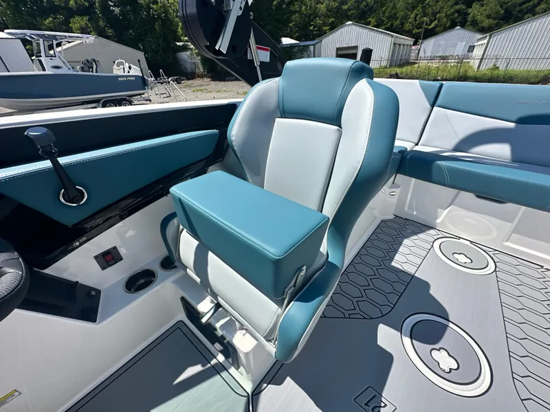 Slide: The Image of 2025 MasterCraft NXT21 boat interior with teal and white seating, modern design. - 6