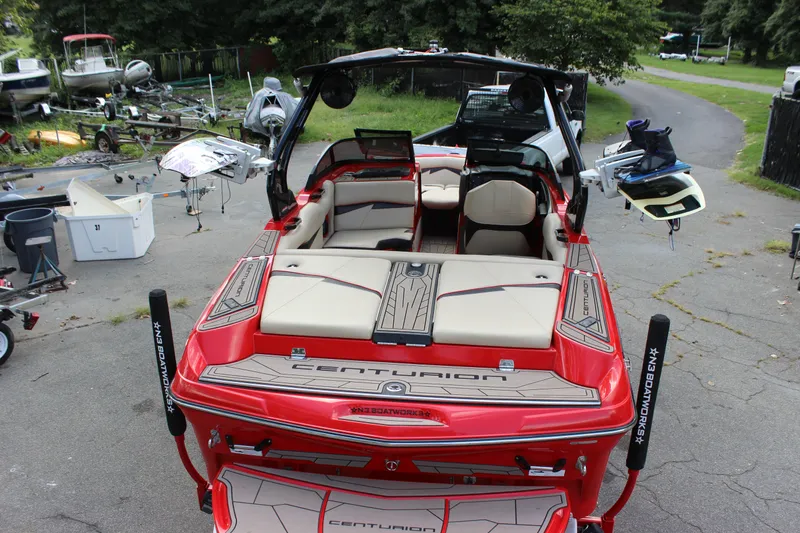 Slide: The Image of Red 2021 Centurion Fi21 boat with open seating, parked outdoors. - 16