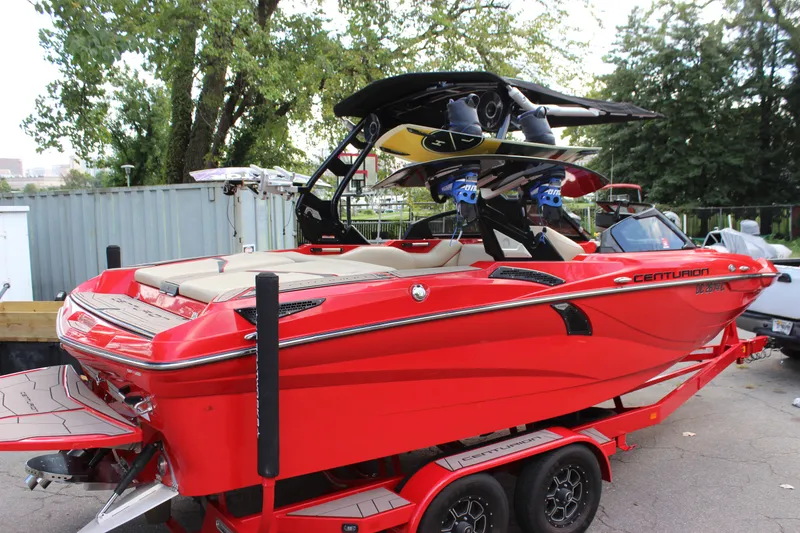 Slide: The Image of Red 2021 Centurion Fi21 boat with wakeboard tower, parked on a trailer. - 18