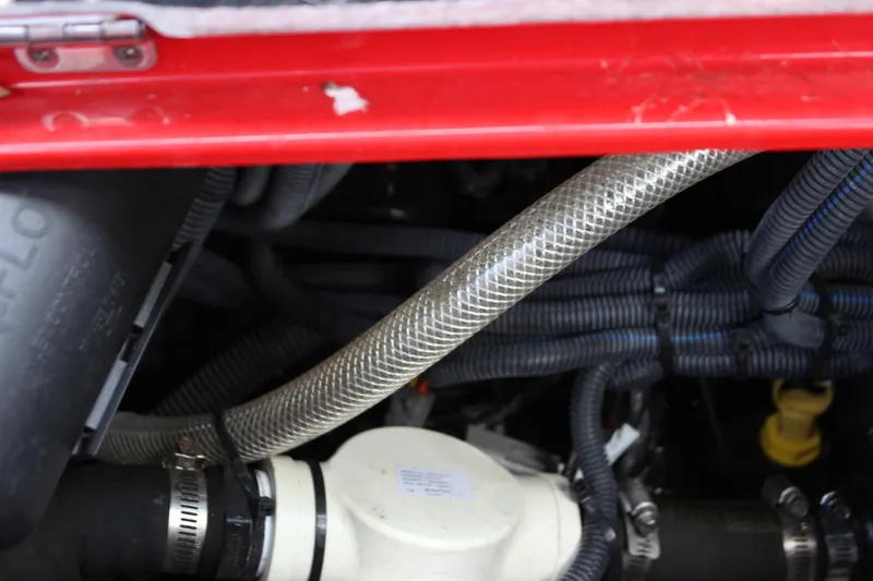 Slide: The Image of Engine compartment of 2021 Centurion Fi21 boat with visible hoses and wiring. - 36