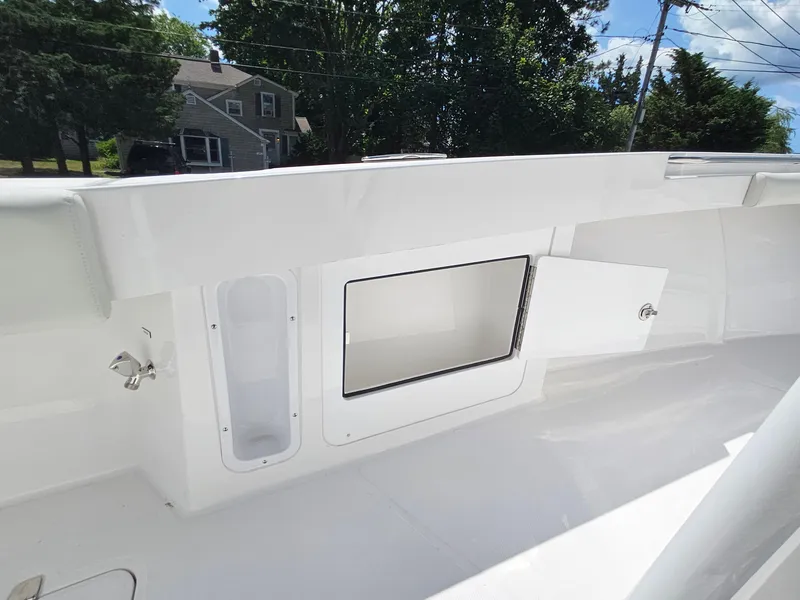 Slide: The Image of 2025 Southport 30 FE boat interior with open storage compartment. - 12
