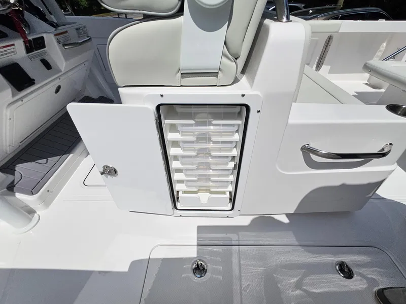 Slide: The Image of 2025 Southport 30 FE boat interior with open storage compartment and seating. - 13