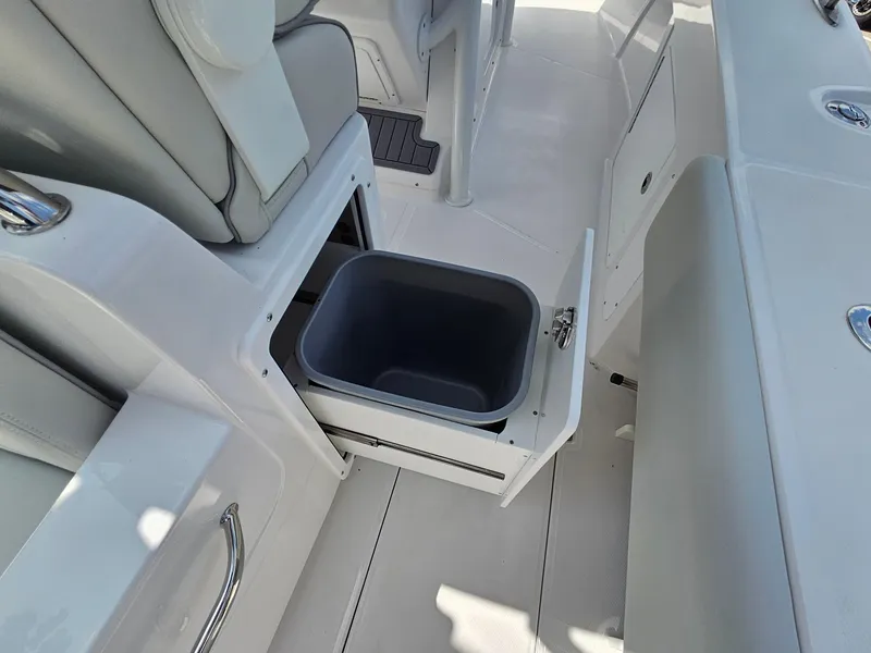 Slide: The Image of 2025 Southport 30 FE boat interior with open storage compartment and bin. - 14