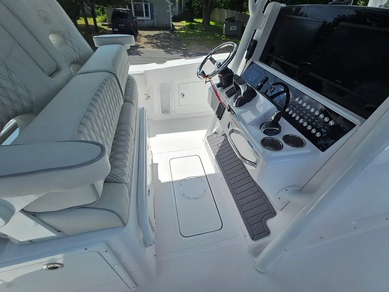Slide: The Image of 2025 Southport 30 FE boat interior with modern helm and seating. - 19