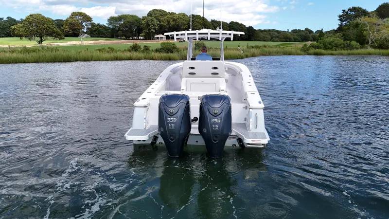 Slide: The Image of 2025 Southport 30 FE boat with dual engines on a calm lake. - 2