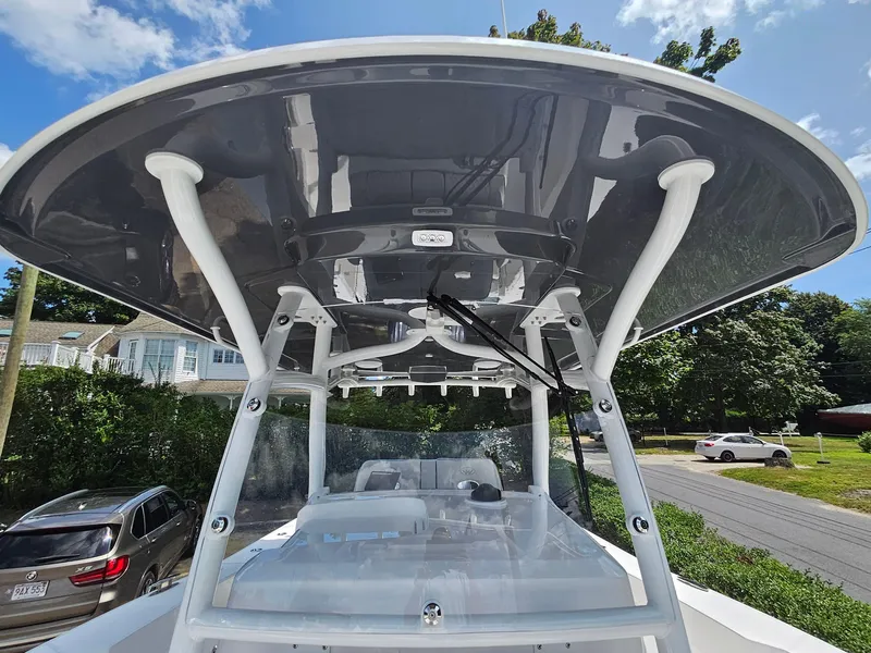 Slide: The Image of 2025 Southport 30 FE boat with sleek T-top design, parked outdoors. - 22