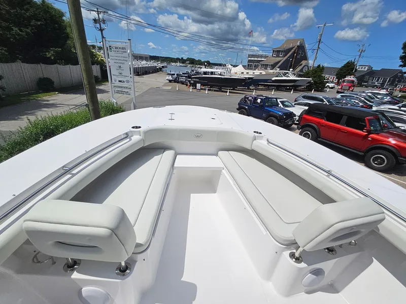 Slide: The Image of 2025 Southport 30 FE boat with spacious seating, docked under a sunny sky. - 24