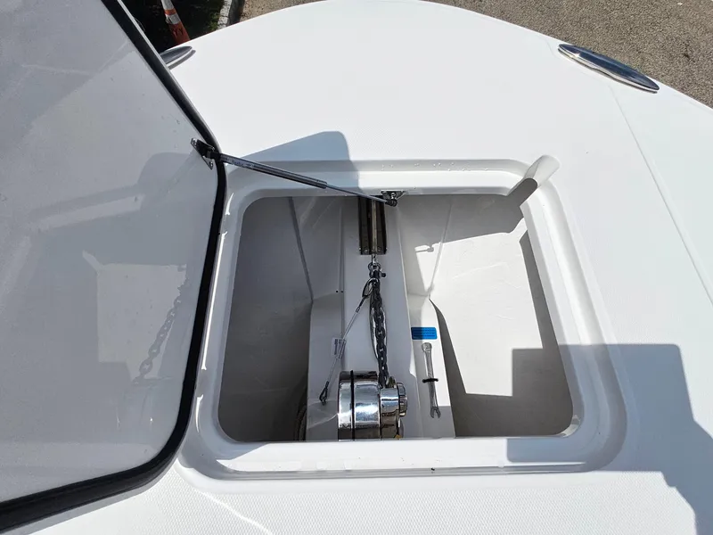 Slide: The Image of Anchor compartment of 2025 Southport 30 FE boat, open lid, chain visible. - 26