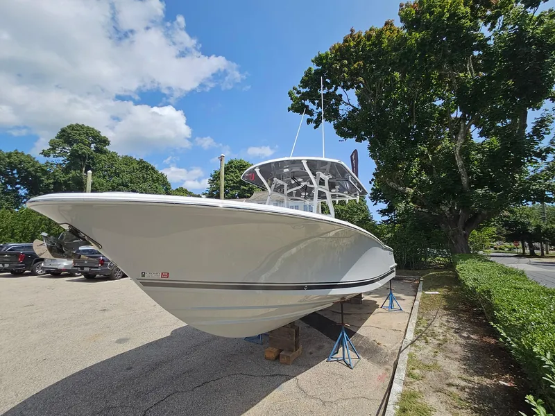 Slide: The Image of 2025 Southport 30 FE boat on display in a sunny parking lot. - 4