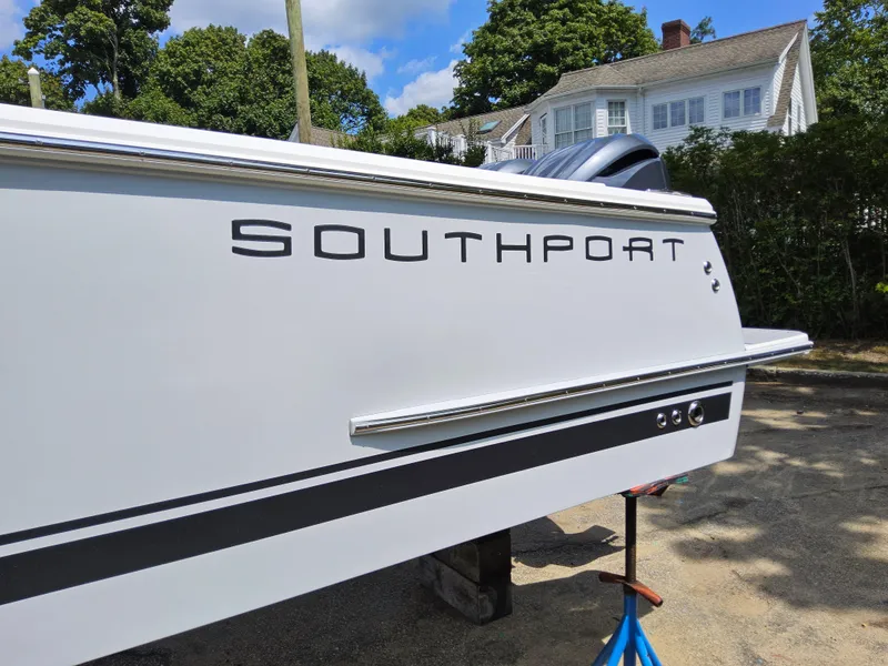 Slide: The Image of 2025 Southport 30 FE boat side view with logo, outdoors. - 7