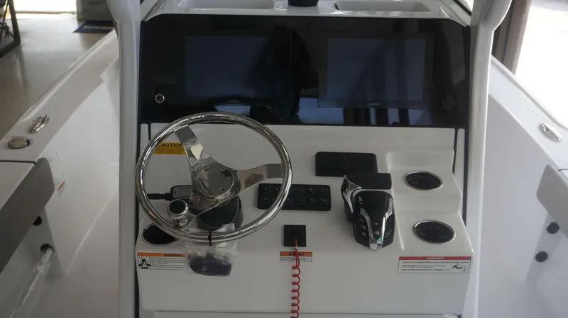 Slide: The Image of 2025 Sportsman 247 MASTERS boat dashboard with steering wheel and control panel. - 10