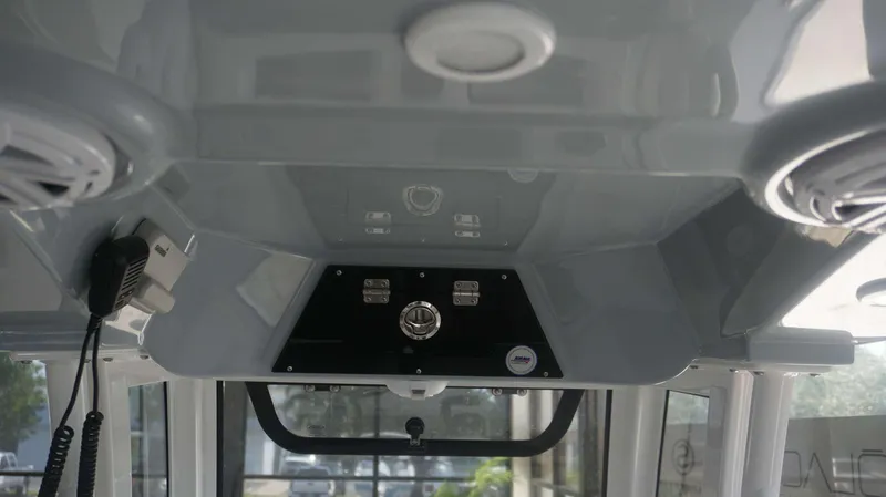 Slide: The Image of Interior view of 2025 Sportsman 247 MASTERS boat console with speakers and controls. - 11