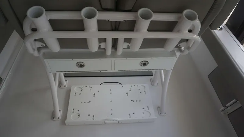 Slide: The Image of Sportsman 247 MASTERS 2025 boat interior with rod holders and storage drawers. - 9