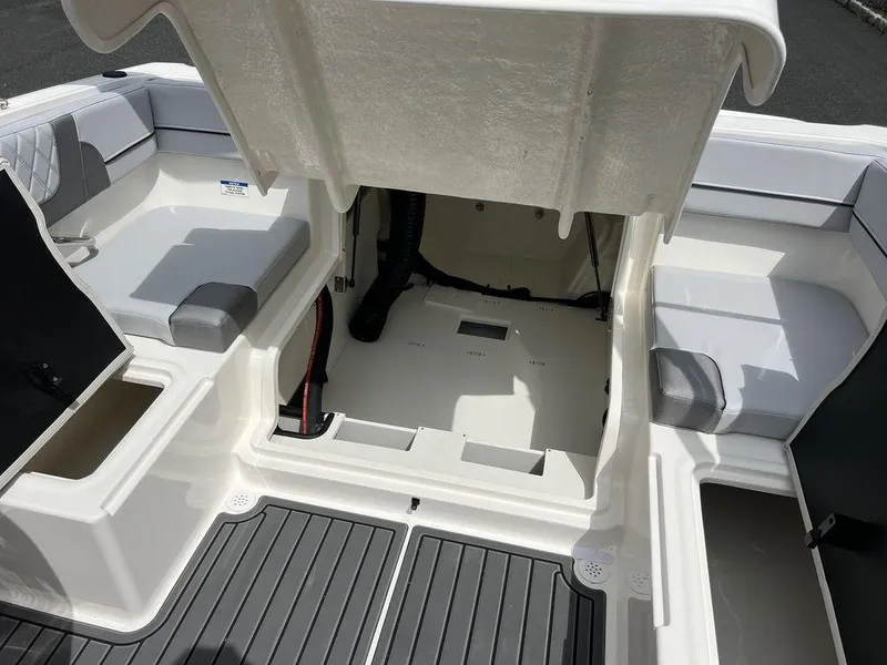Slide: The Image of 2025 Bayliner VR4 Bowrider Outboard interior with open storage compartment. - 10