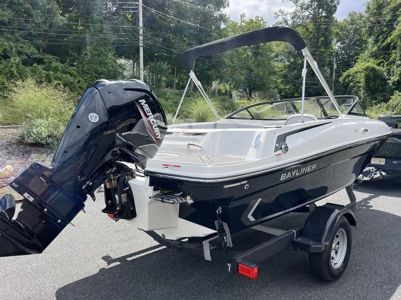 Slide: The Image of 2025 Bayliner VR4 Bowrider Outboard on trailer, parked outdoors. - 6