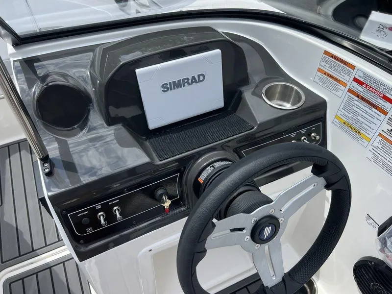 Slide: The Image of 2025 Bayliner VR4 Bowrider dashboard with Simrad display and steering wheel. - 9