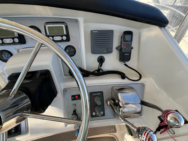 Slide: The Image of 2008 Carver 360 Sport Sedan helm with steering wheel, controls, and navigation instruments. - 15