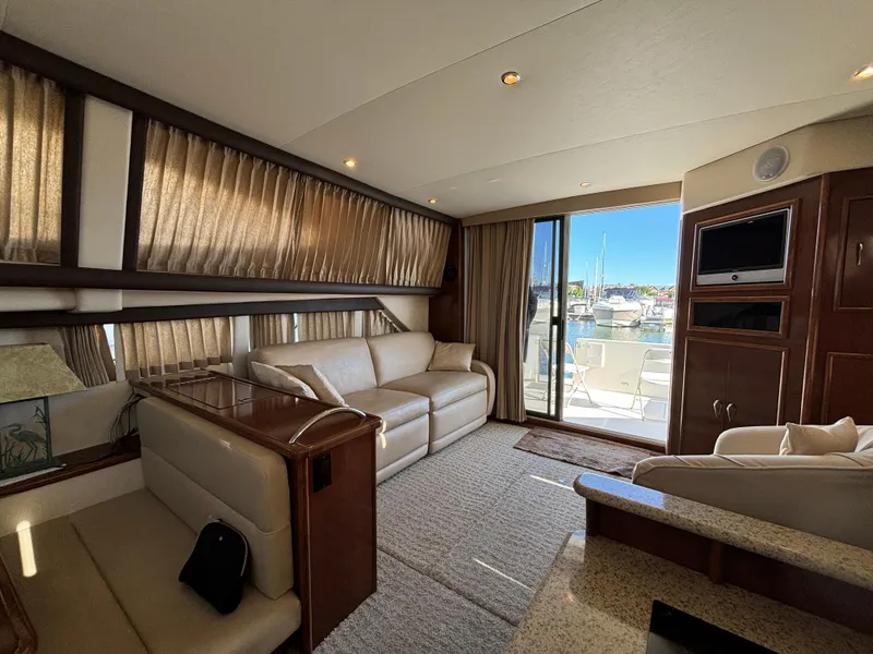 Slide: The Image of Luxurious interior of a 2008 Carver 360 Sport Sedan yacht with plush seating and marina view. - 2