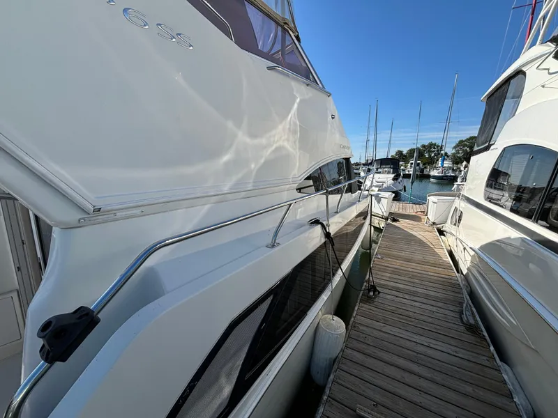 Slide: The Image of 2008 Carver 360 Sport Sedan docked at marina under clear blue sky. - 24