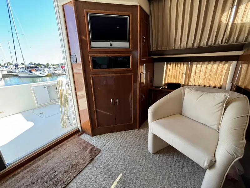 Slide: The Image of Interior of 2008 Carver 360 Sport Sedan with TV, chair, and marina view. - 34