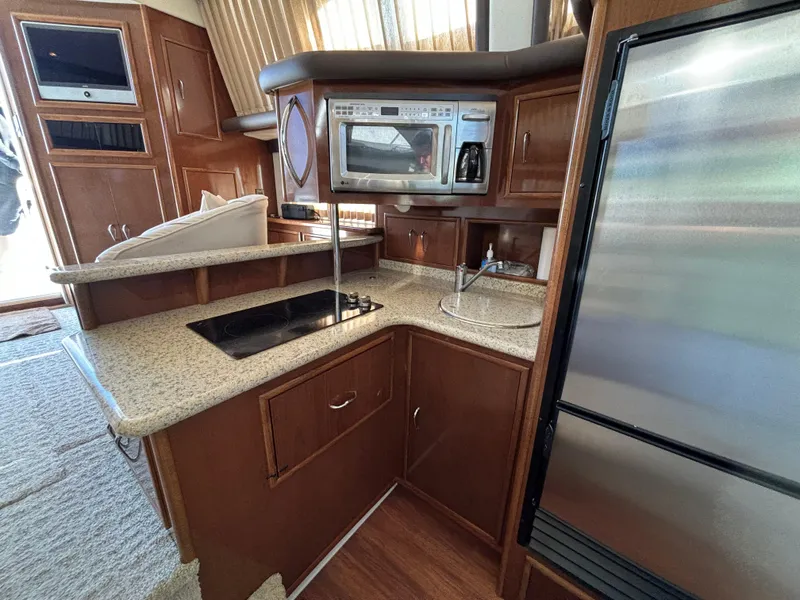 Slide: The Image of 2008 Carver 360 Sport Sedan kitchen with modern appliances and wood cabinetry. - 38
