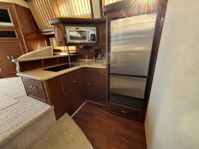 Slide: The Image of 2008 Carver 360 Sport Sedan kitchen with stainless steel appliances and wood cabinetry. - 39
