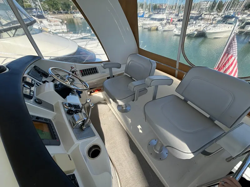 Slide: The Image of 2008 Carver 360 Sport Sedan helm with dual seats, overlooking marina. - 4