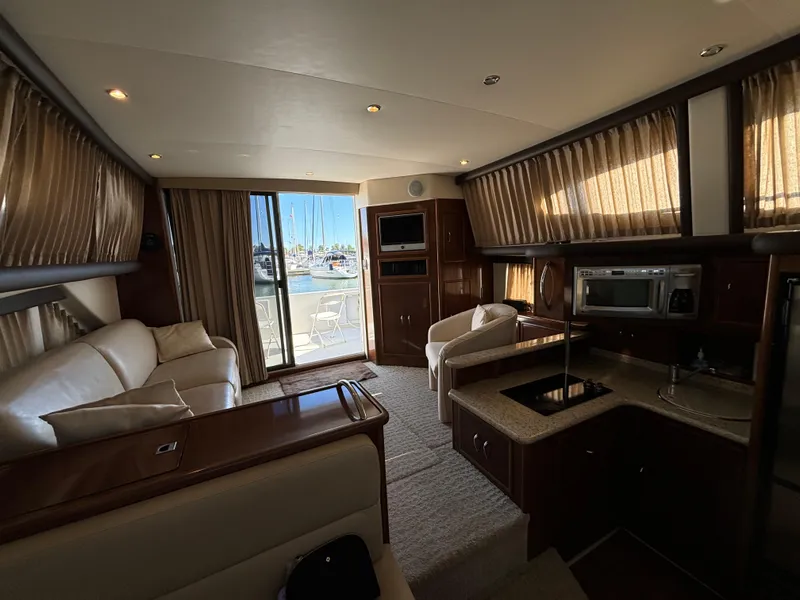 Slide: The Image of Interior of 2008 Carver 360 Sport Sedan with luxurious seating and kitchenette. - 40